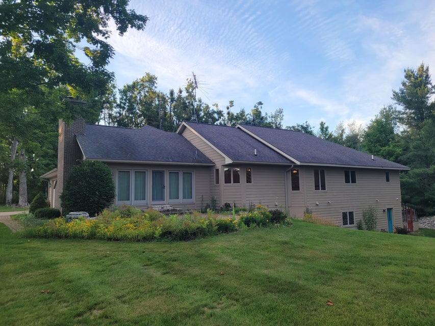 Rear exterior of the home overlooking lawn and gardens